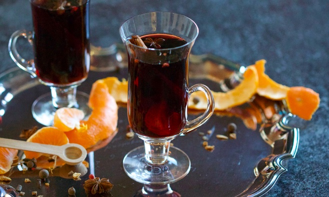 Hot Wine and spices winter treats and drinks silver tray and oranges